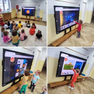 Dzieci przy tablicy multimedialnej, rozwiązujące zadania o tematyce kosmosu.