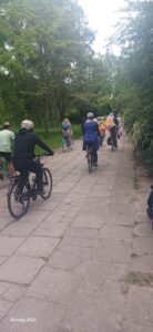 Grupa dzieci i rodziców podczas rajdu rowerowego